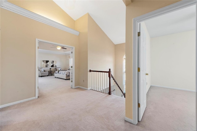 hallway with an upstairs landing, baseboards, carpet floors, and high vaulted ceiling