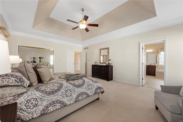 bedroom with a raised ceiling, multiple windows, crown molding, and light carpet