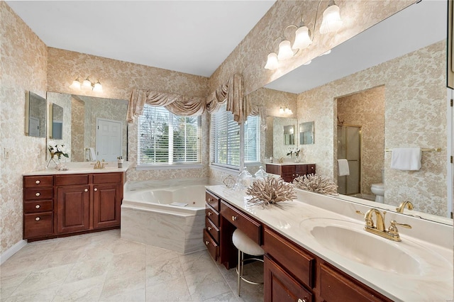 bathroom with a shower stall, toilet, a bath, and a sink