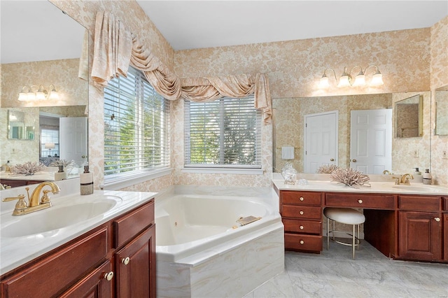 full bath with a whirlpool tub, wallpapered walls, two vanities, and a sink