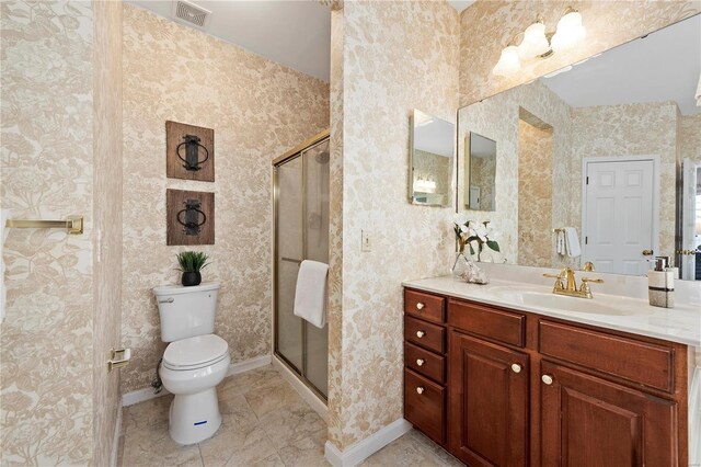 bathroom with vanity, baseboards, visible vents, a shower stall, and toilet