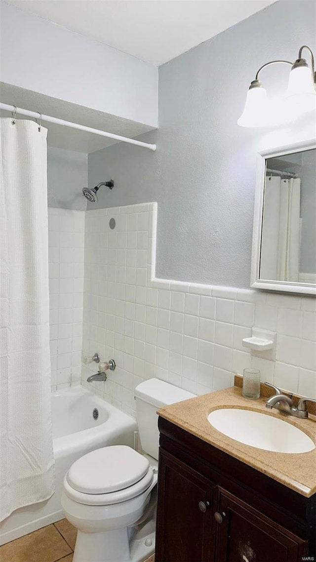 bathroom featuring vanity, tile patterned flooring, shower / bath combo with shower curtain, tile walls, and toilet