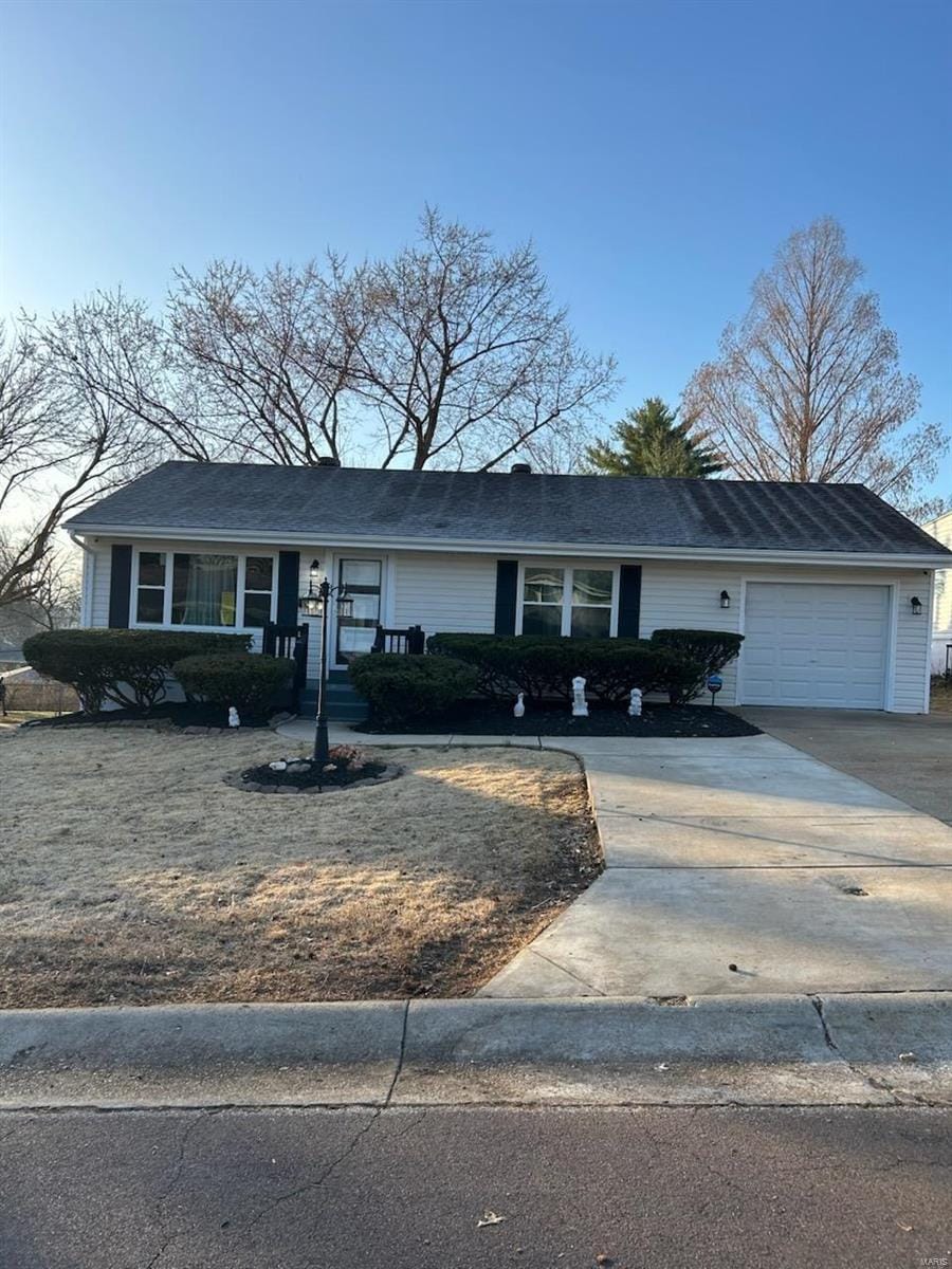 ranch-style home featuring driveway and an attached garage