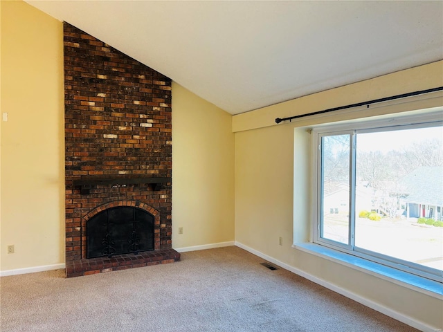 unfurnished living room with visible vents, a brick fireplace, carpet, and lofted ceiling