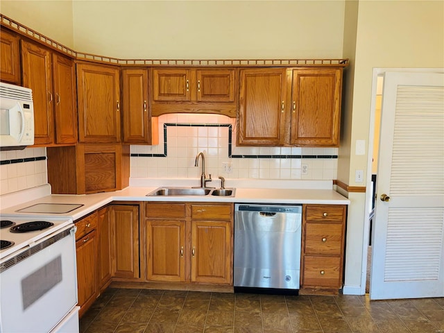 kitchen with tasteful backsplash, light countertops, brown cabinets, white appliances, and a sink