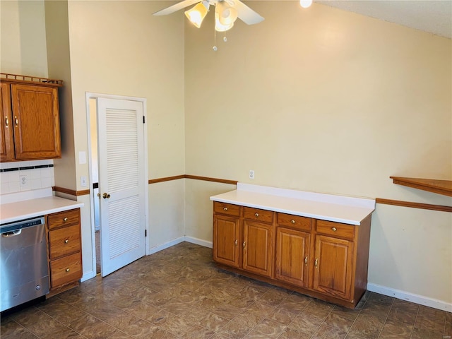 kitchen with baseboards, brown cabinets, stainless steel dishwasher, and a ceiling fan