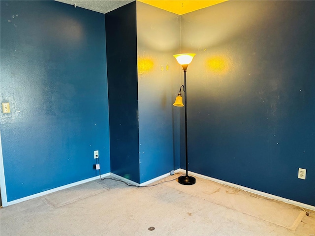 empty room with baseboards and carpet flooring