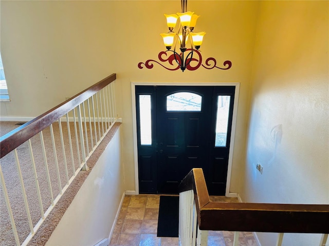 entryway with stairs, baseboards, and a chandelier