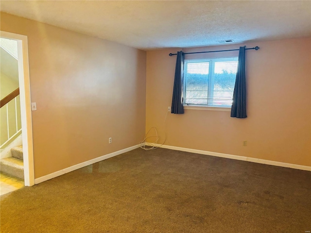 spare room with stairway, baseboards, visible vents, and carpet floors