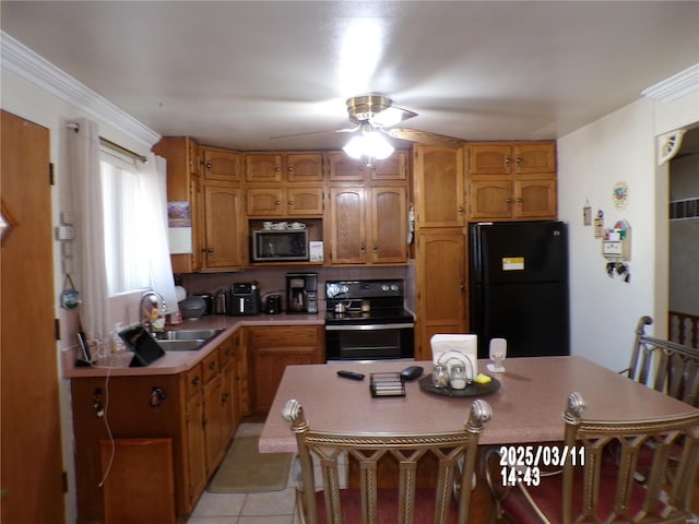 kitchen with a ceiling fan, a sink, range with electric stovetop, freestanding refrigerator, and light tile patterned floors