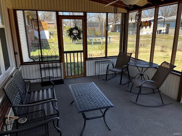 sunroom with a ceiling fan, a healthy amount of sunlight, and radiator