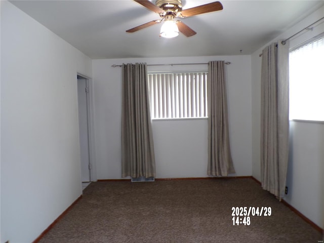 spare room with carpet floors and a ceiling fan