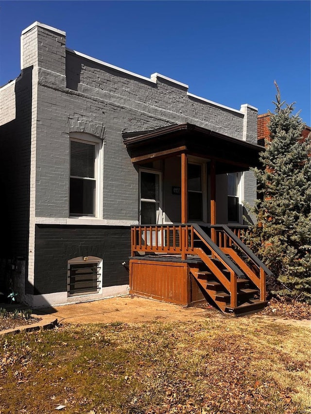 back of house featuring brick siding