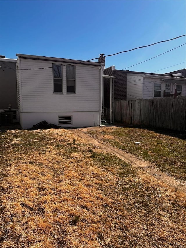 exterior space with fence and central AC