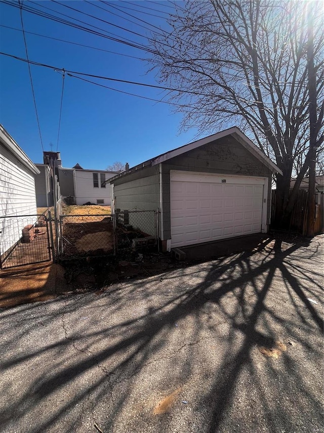 detached garage featuring fence