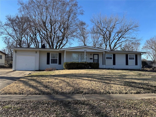 ranch-style home featuring concrete driveway, an attached garage, a front yard, and a chimney