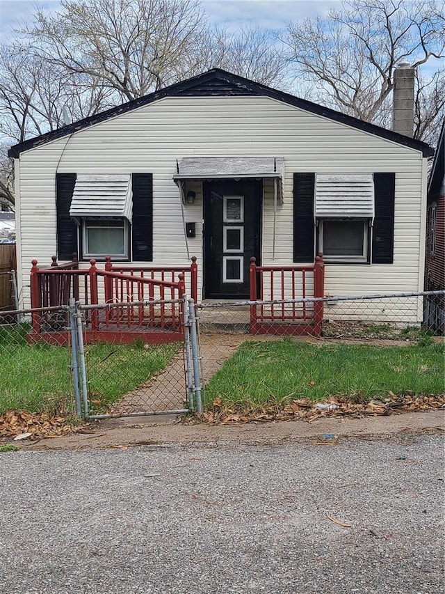 bungalow with a gate, covered porch, and a fenced front yard