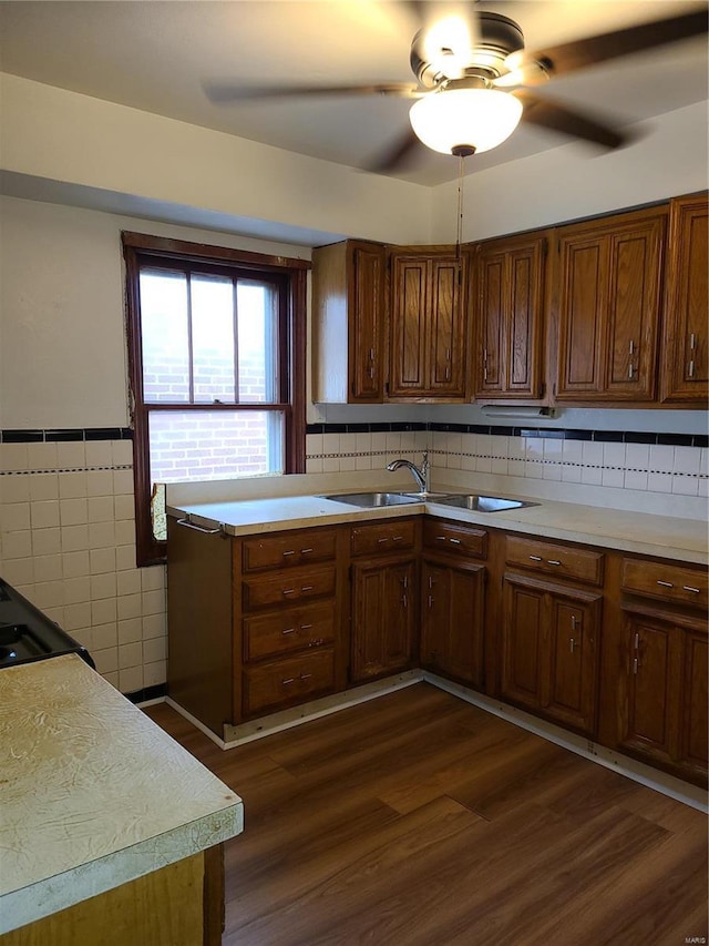 kitchen featuring dark wood-style flooring, light countertops, ceiling fan, and a sink