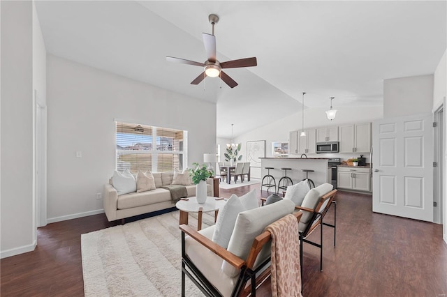 living room featuring dark wood-type flooring, baseboards, lofted ceiling, and ceiling fan