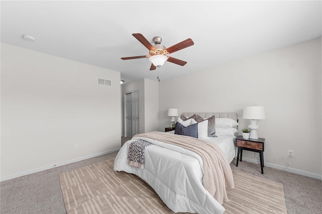 bedroom featuring visible vents, baseboards, light colored carpet, and ceiling fan