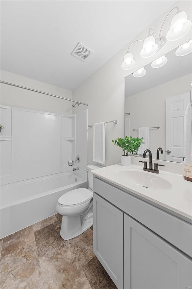 bathroom with vanity, toilet, visible vents, and shower / washtub combination