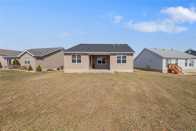 back of property featuring a patio area and a lawn