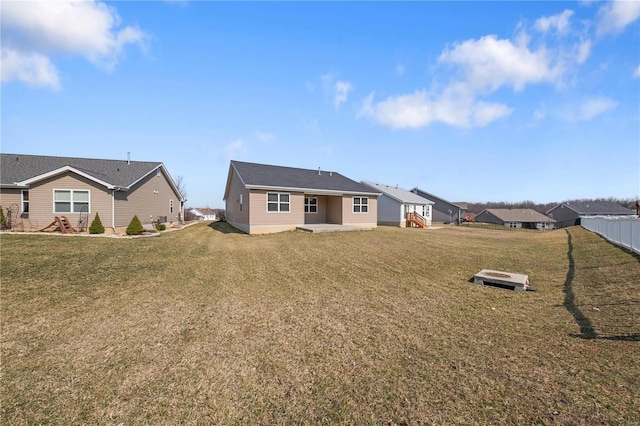 rear view of house featuring a yard and a patio area