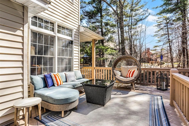 wooden terrace with an outdoor living space