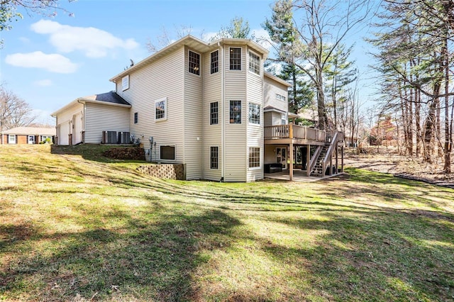 rear view of property featuring a yard, a patio, a wooden deck, and stairway