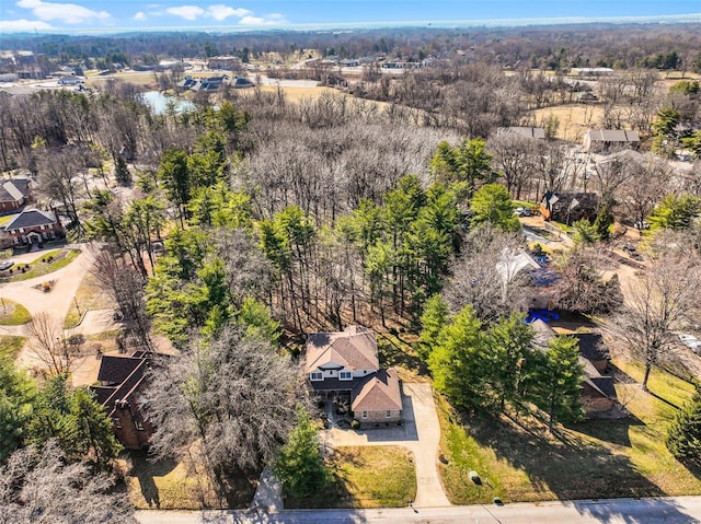 birds eye view of property featuring a view of trees