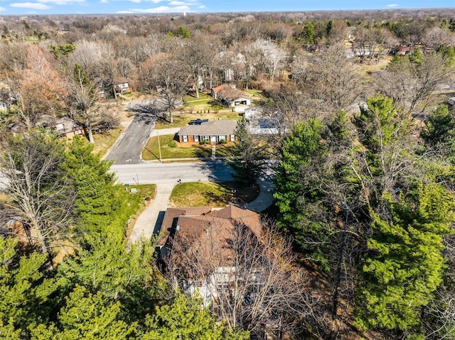 birds eye view of property featuring a wooded view