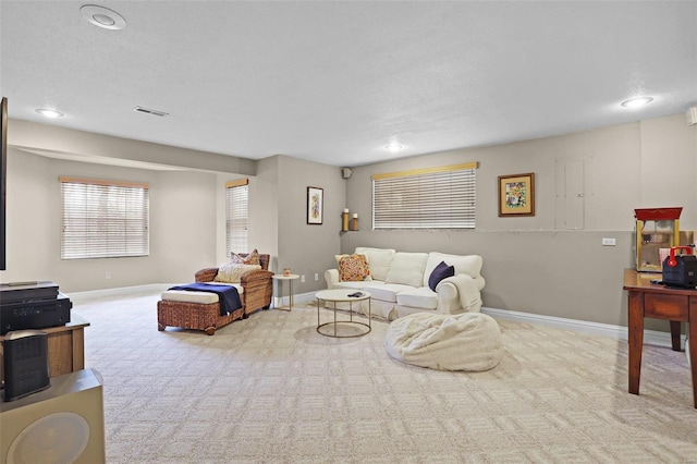 carpeted living area featuring recessed lighting, baseboards, and visible vents