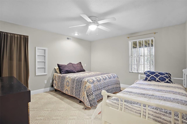 carpeted bedroom featuring visible vents, ceiling fan, and baseboards