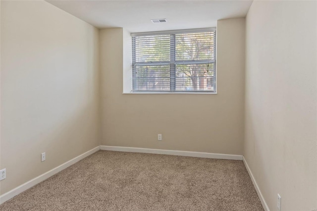 unfurnished room featuring visible vents, baseboards, and carpet