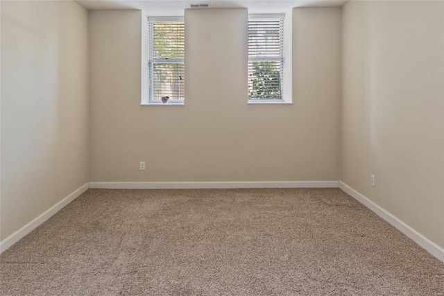 carpeted spare room with baseboards