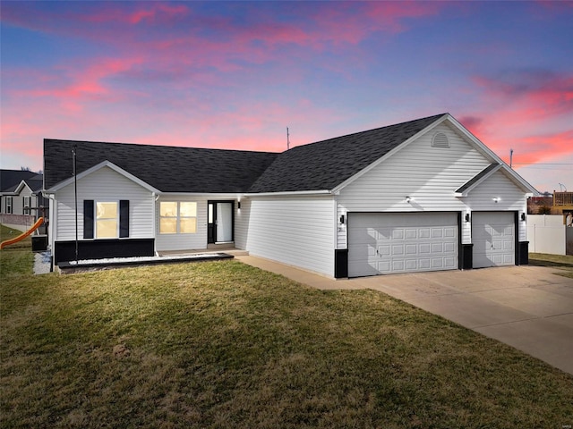 ranch-style house with a front yard, concrete driveway, and an attached garage