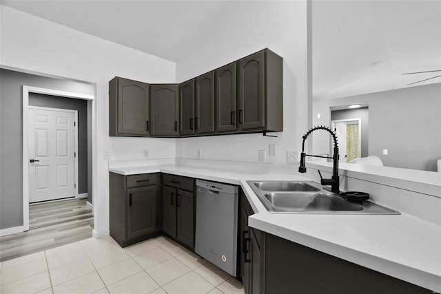 kitchen with vaulted ceiling, dishwasher, light countertops, and a sink