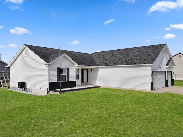 exterior space featuring driveway, roof with shingles, an attached garage, a yard, and central air condition unit