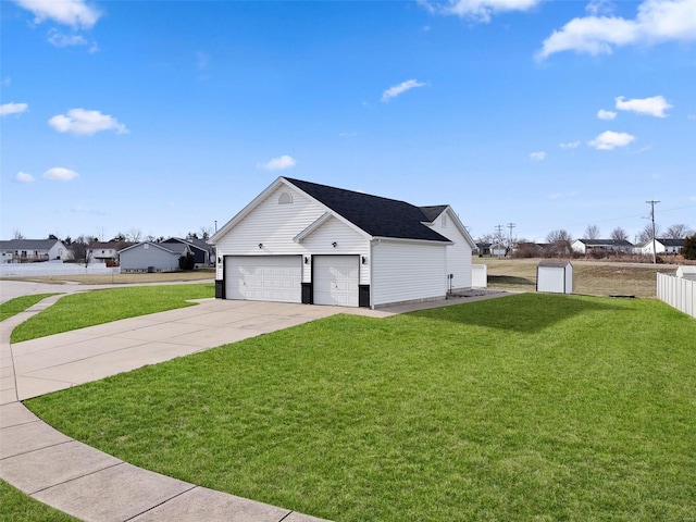 view of side of home with a yard, an attached garage, and driveway