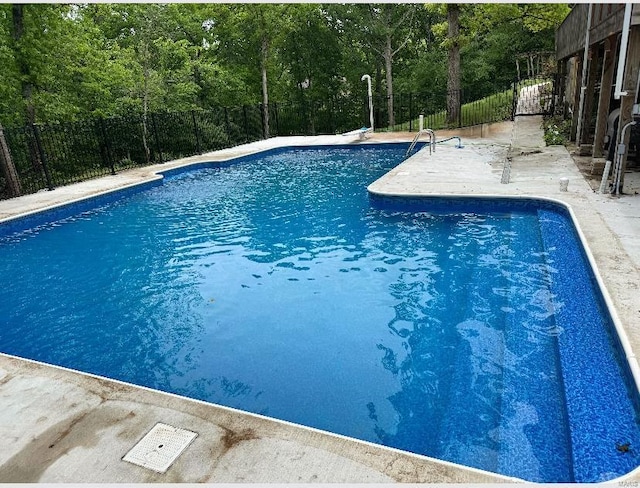 view of swimming pool featuring a fenced in pool, a patio, and a fenced backyard