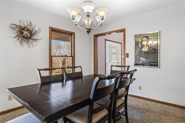 dining space with baseboards, carpet floors, and an inviting chandelier