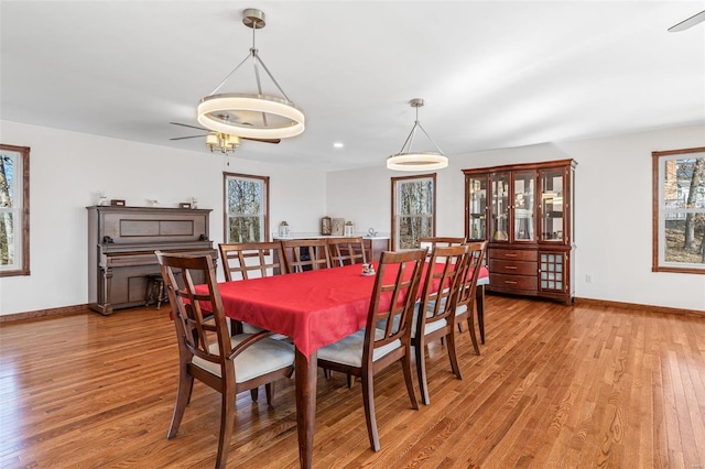 dining room featuring baseboards and light wood-type flooring