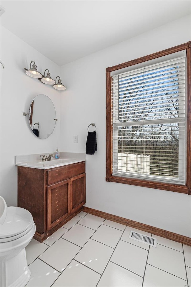 bathroom featuring visible vents, toilet, vanity, and tile patterned flooring