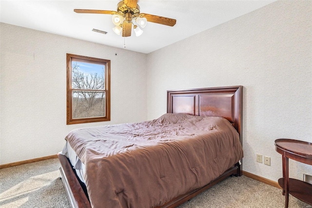 carpeted bedroom with a ceiling fan, baseboards, and visible vents