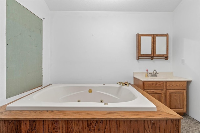 full bath featuring vanity and a jetted tub