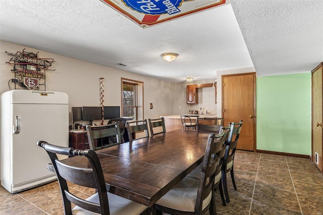 dining area with visible vents, baseboards, and a textured ceiling