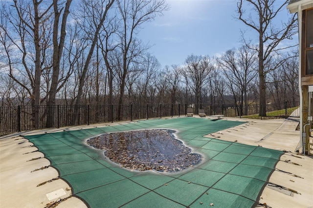 view of pool with a patio area, a fenced in pool, a diving board, and fence