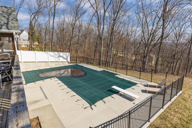 view of swimming pool with a fenced in pool, a patio, and fence