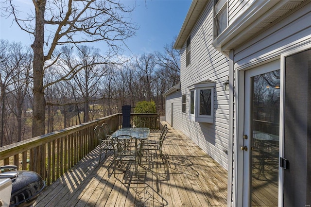 wooden terrace featuring outdoor dining area