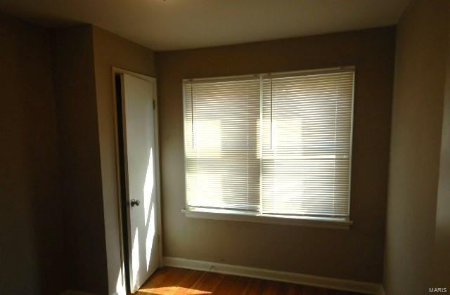 empty room featuring baseboards and wood finished floors